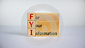 Wood blocks with acronym `FYI` - `for your information` on beautiful white background, copy space. Business concept