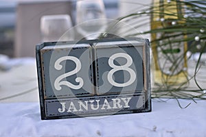 Wood blocks in box with date, day and month 28 January