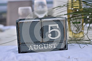Wood blocks in box with date, day and month 5 August