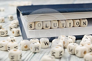 Wood blocks with letters spelling Solution . Wooden ABC.