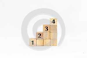 Wood blocks stacked with numbers 1, 2, 3 and 4 isolated on white background