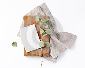 Wood board with blank menu card on linen napkin isolated on white background