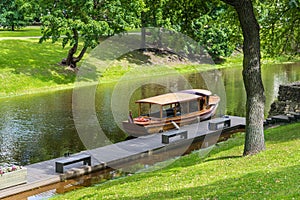 Wood boat on the city river in the central park of Riga, Latvia.