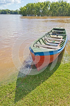 Wood boat during a flood at Rio Pardo river photo