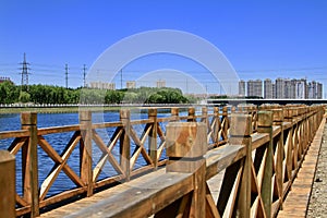 Wood bridge on a river in city