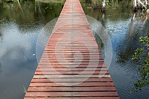 Wood bridge walkway along river