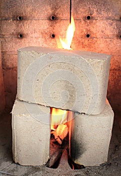 Wood briquettes burning in stove photo