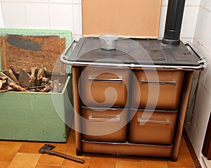 Wood burning stove in a kitchen of a mountain home and the axe 2 photo