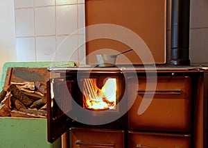 Wood burning stove in a kitchen of a mountain home with a pot on photo