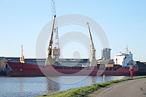 Wood carrier at the timber factory in Ouderkerk at the river Hollandse IJssel in the Netherlands