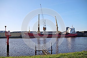 Wood carrier at the timber factory in Ouderkerk at the river Hollandse IJssel in the Netherlands