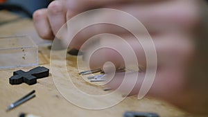 Wood carver chooses drill bits for wood processing machine. The sounds of hand instruments