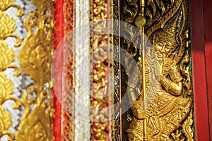 Wood carving door decorated with stained glass in the temple