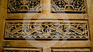 wood carving, floral pattern carved on wooden background. gebyok.