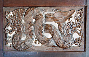 Wood carving of nagas