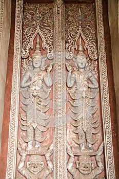 Wood Carving Pictures on the doors of Haw Phra Kaew temple at Vientiane, Laos.