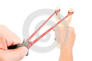 Wood catapult slingshot with hand on white background