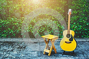 Wood chair and acoustic guitar in terrace