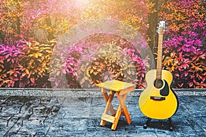 Wood chair and acoustic guitar in terrace