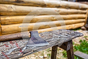 Wood chopper or axe are used for building wood house from lumber pine and slivers on the ground