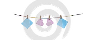 Wood clothes peg with two blank pink paper in heart shaped and two blank blue paper hanging on string isolated on white background