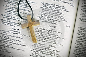 Wood Cross Sign Symbol and Praying to God with a Bible in the Morning Devotion photo