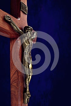 Wood crucifix on navy blue background