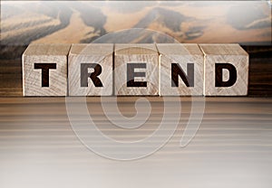 Wood cube block with word Trend on wooden table. Business success concept