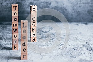 Wood cube letter word of Leader, teamwork, and success with copy space. Idea of motivation or inspiration in business vision and