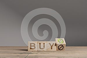 Wood cubes with acronym `BUY` on a beautiful wooden table, studio background. Business concept and copy space