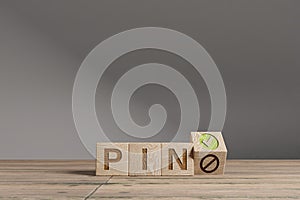 Wood cubes with acronym `PIN` on a beautiful wooden table, studio background. Business concept and copy space