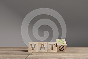 Wood cubes with acronym `VAT` - `Value Added Tax` on a beautiful wooden table, studio background. Business concept and copy sp