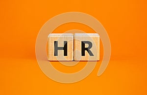 Wood cubes with letteres hr on beautiful orange background, copy space. Business, employment and human resources conceptual image