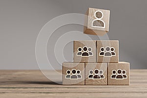 Wood cubes with new head of team or CEO on a beautiful wooden table, studio background. Business concept and copy space
