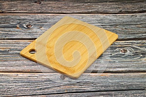 Wood cutting board for homemade bread cooking isolated on rusty background. Empty wooden tray at rusty