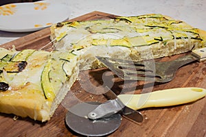 Wood cutting board with pizza and knife