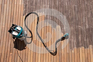 Orbital power sander and dust collector on ipe decking