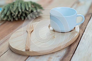 Wood dish and coffe cup on wooden table.with Text Space