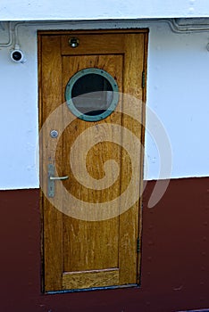 Wood door with port hole on a boat.