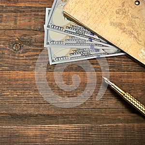 Wood Empty Background With Notebook, Money And Golden Pen