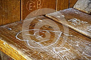 Wood engraving of a love heart on a wooden bench