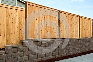 Wood Fence on Stone Retaining Wall on Side of Home photo