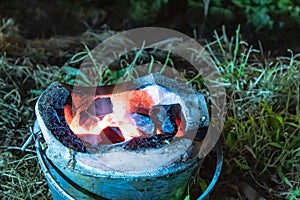 Wood firebrand in the oven On the grass.