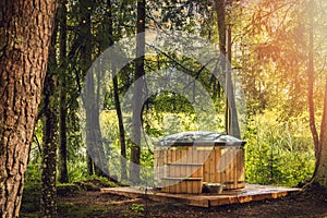 Wood fired hot tub in the forest photo