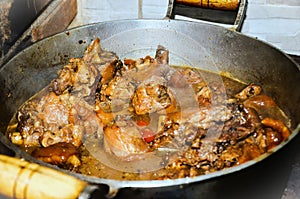 Chicken meat with pig`s feet, gallop, cooking in a wood-fired oven photo