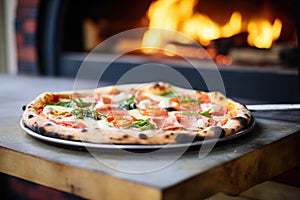 wood-fired pizza in a brick oven, flames visible