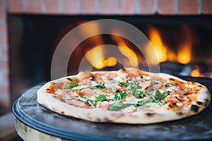 wood-fired pizza in a brick oven, flames visible