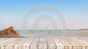 Wood floor against blur nature sea beach abstract background