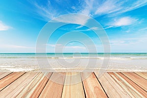 Wood floor on beach and blue sky background