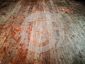 Scuffed dirty hardwood floor, showing red stains resembling blood - abandoned house, scary horror scene background photo